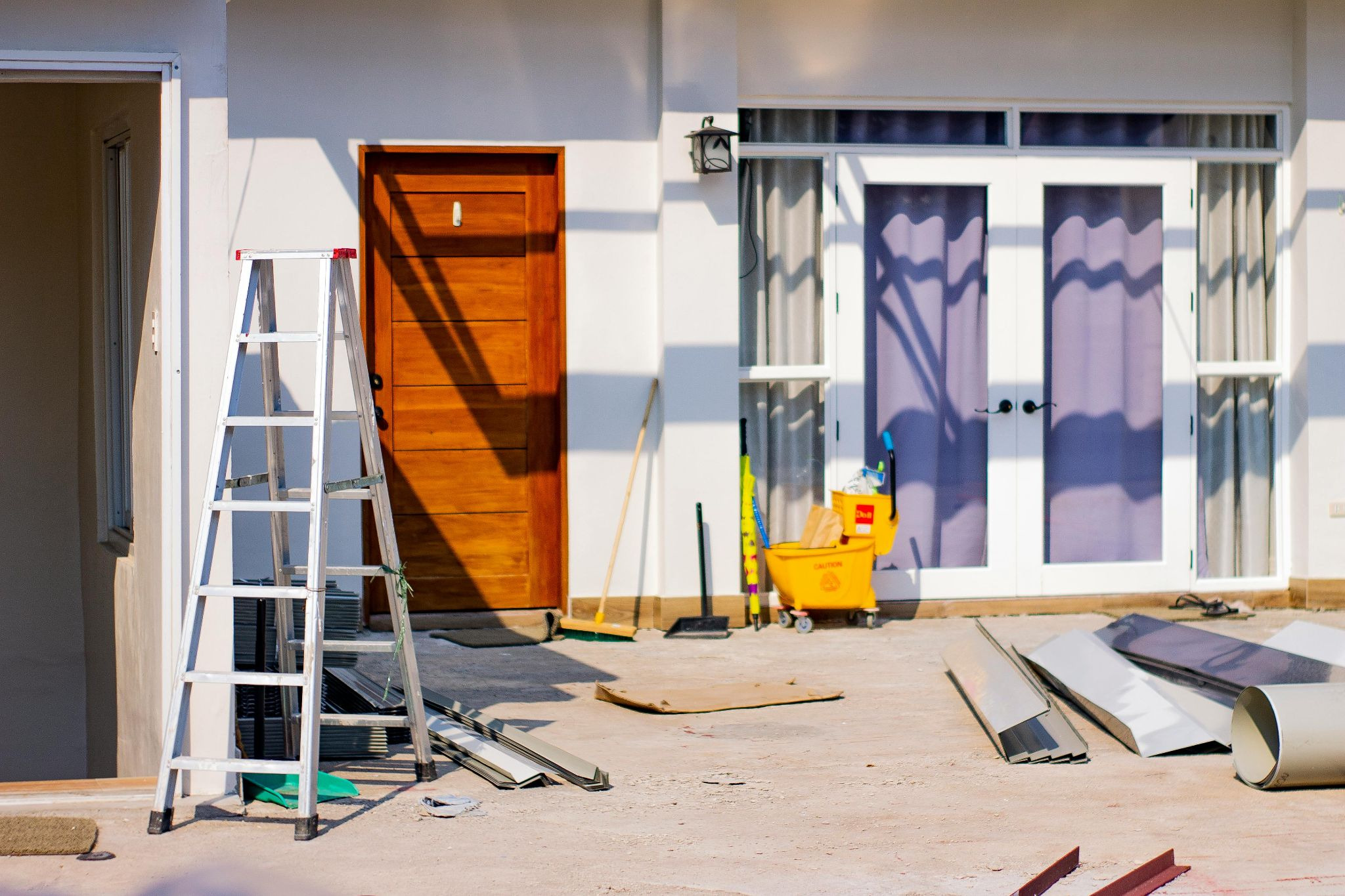 Maintenance Materials, a Ladder, and a Mop Bucket, Outside a House