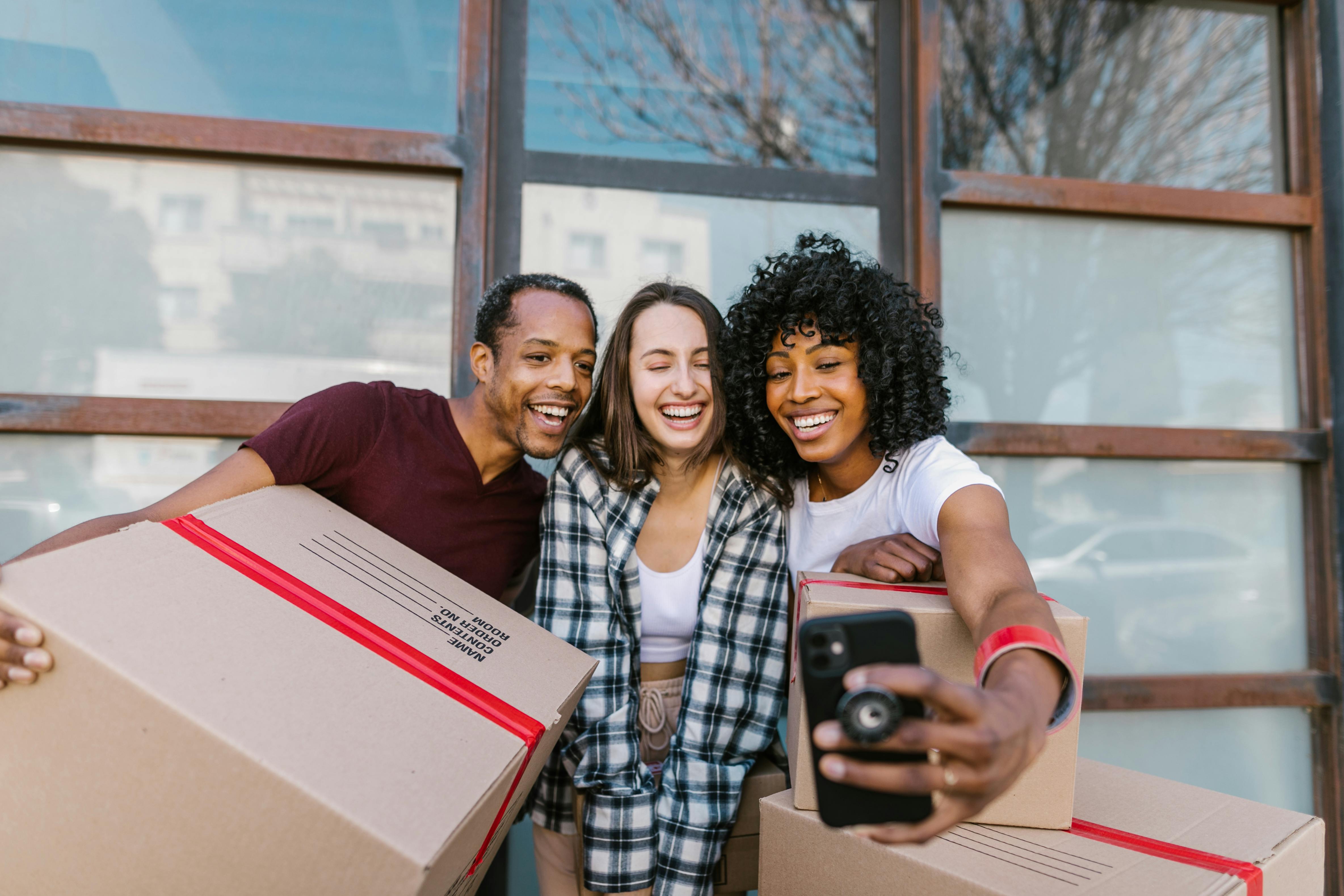 Happy Diverse Renters Take a Move-in Selfie 