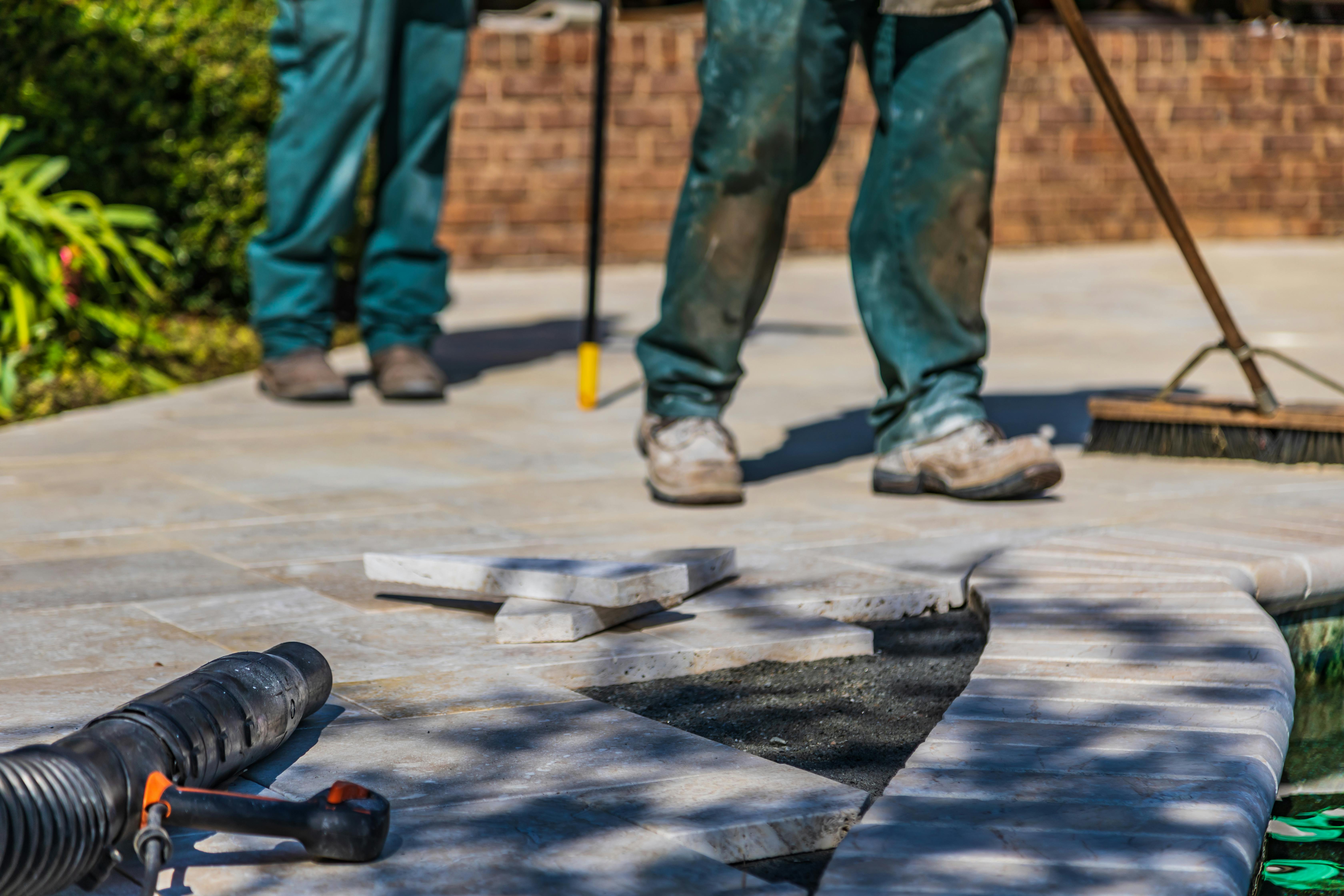 property managers doing maintenance on a stone walkway