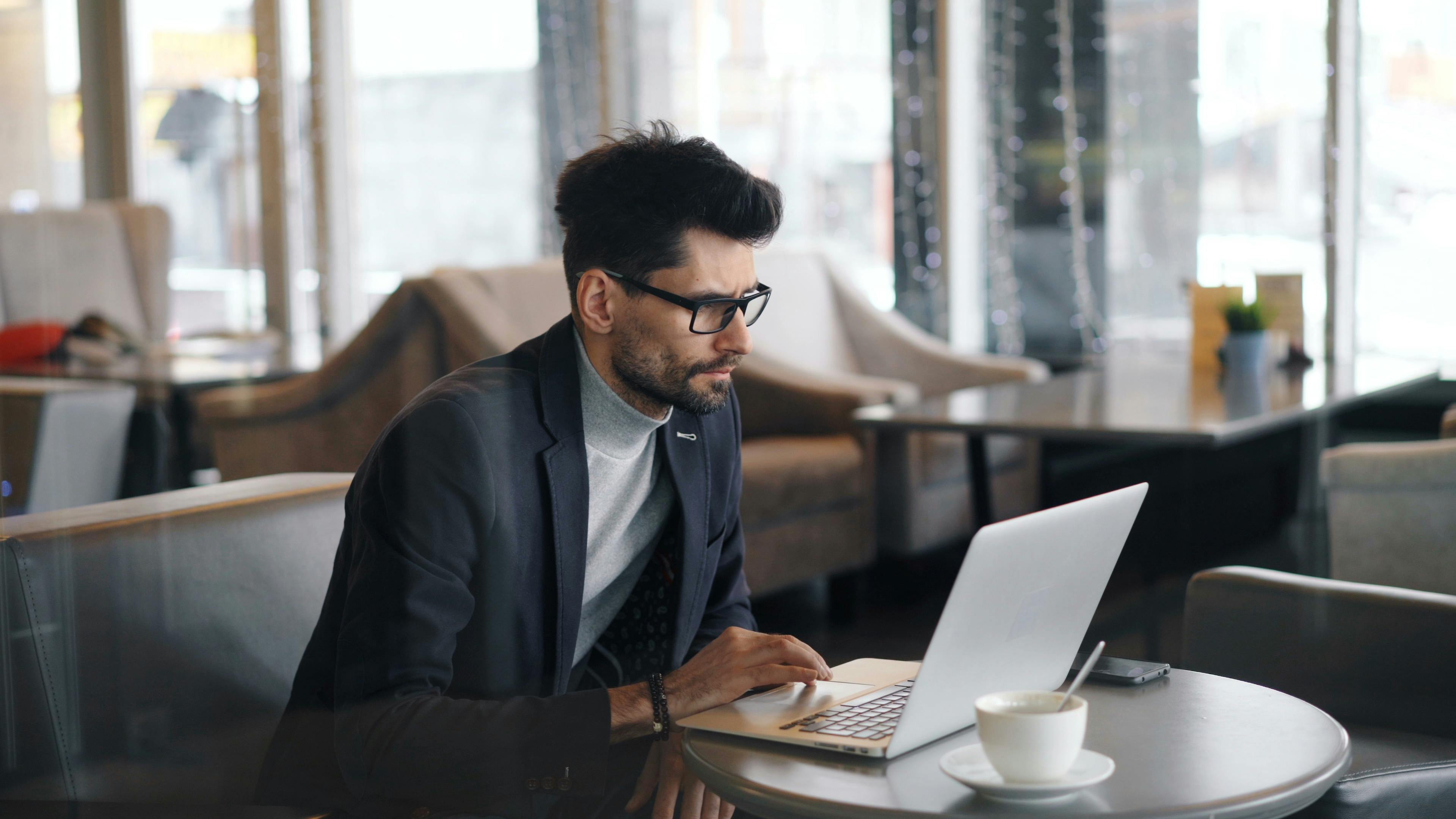 A landlord checks rental statements on their laptop