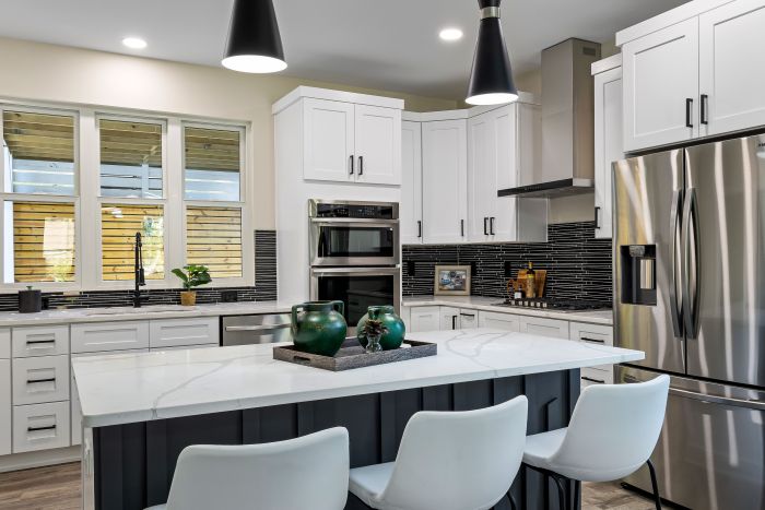Modern white kitchen with tall countertops and abundant natural light